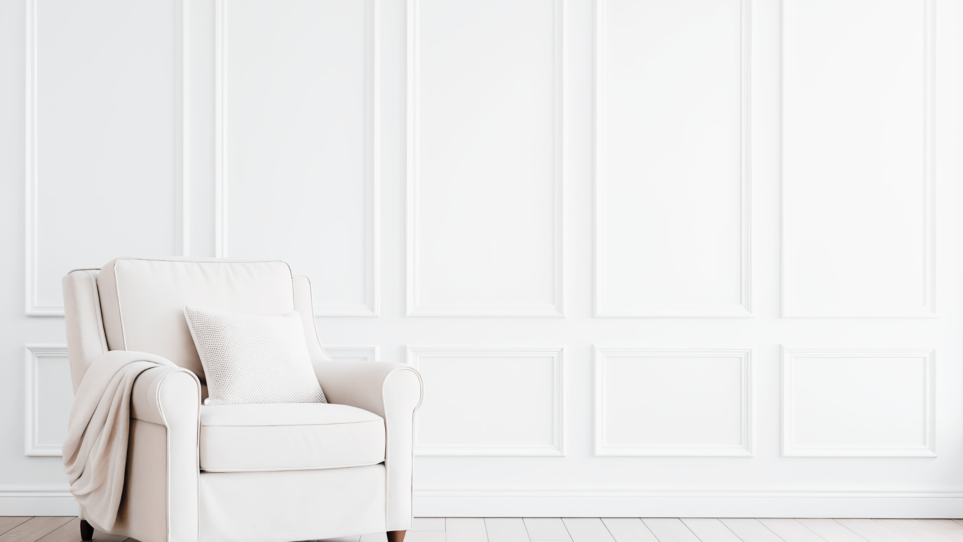 Class white armchair against a white panelled wall