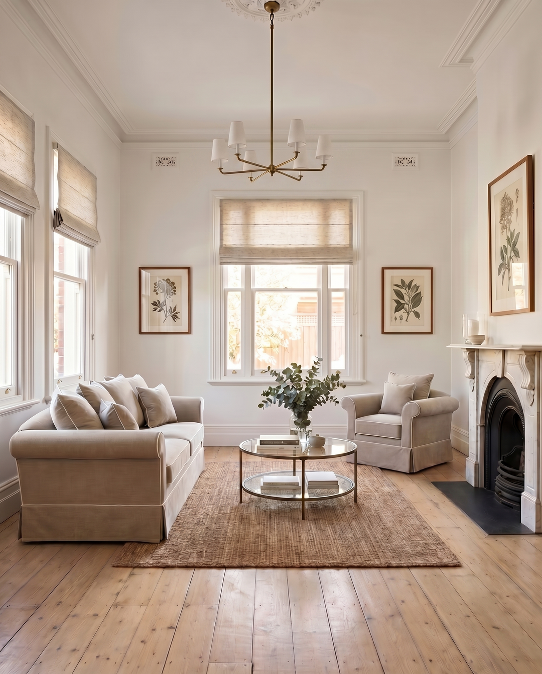 A bright Victorian sitting room with polished timber floorboards, traditional fireplace and aged brass light fitting.