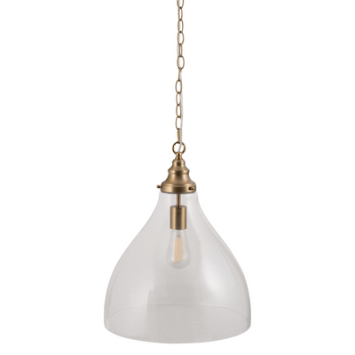 Pendant light with clear glass shade and brass fixture on a white background